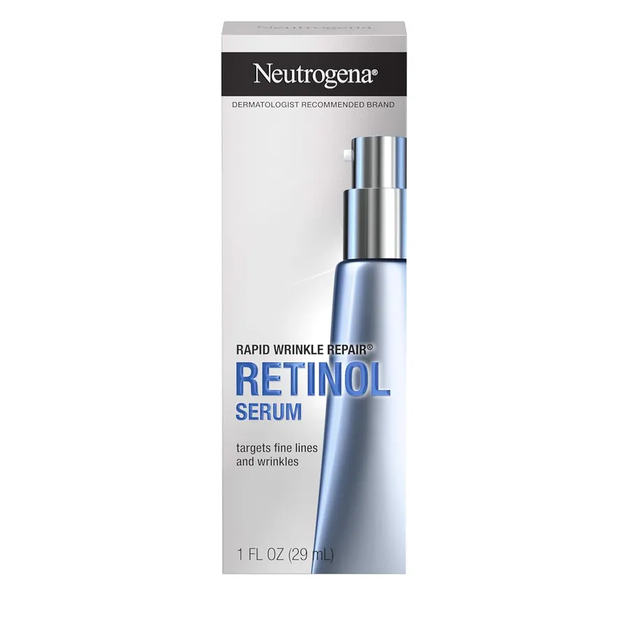 Hand holding the Neutrogena Rapid Wrinkle Repair Retinol Serum bottle against a soft cream background
