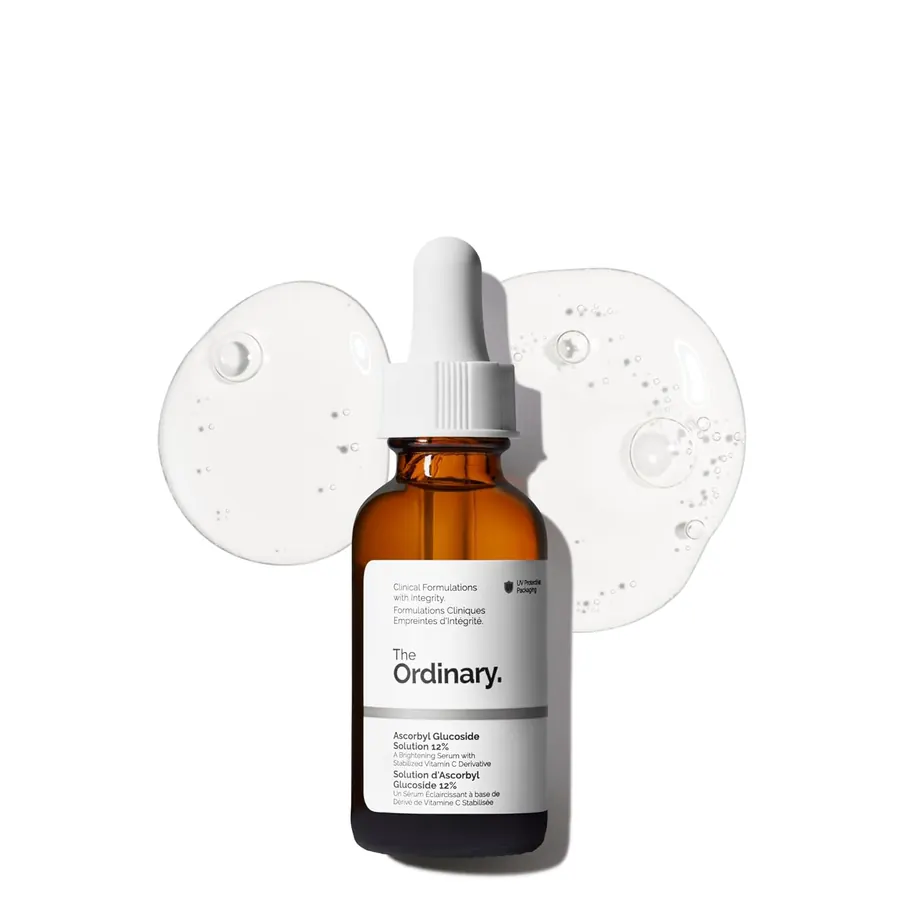 Hand holding a dropper bottle of The Ordinary vitamin C serum over a palm, one to two drops dispensed